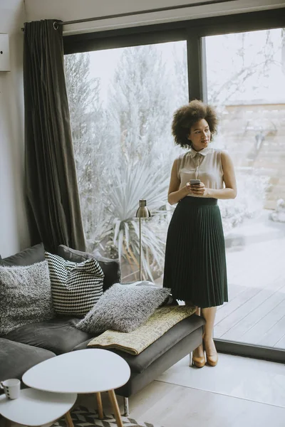 Pretty Young Woman Curly Hair Using Mobile Phone Window Home — Stock Photo, Image