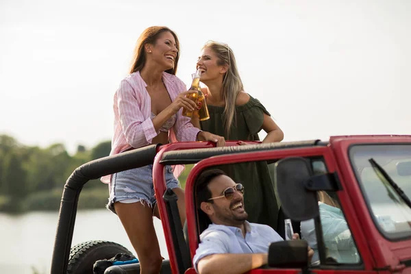 Group of happy young people enjoying road trip