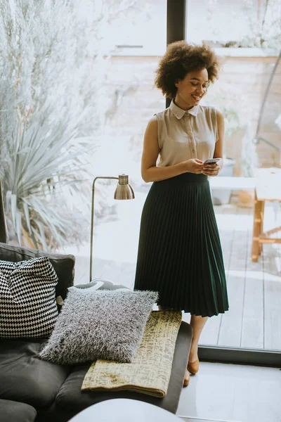 Pretty Young Woman Curly Hair Using Mobile Phone Window Home — Stock Photo, Image