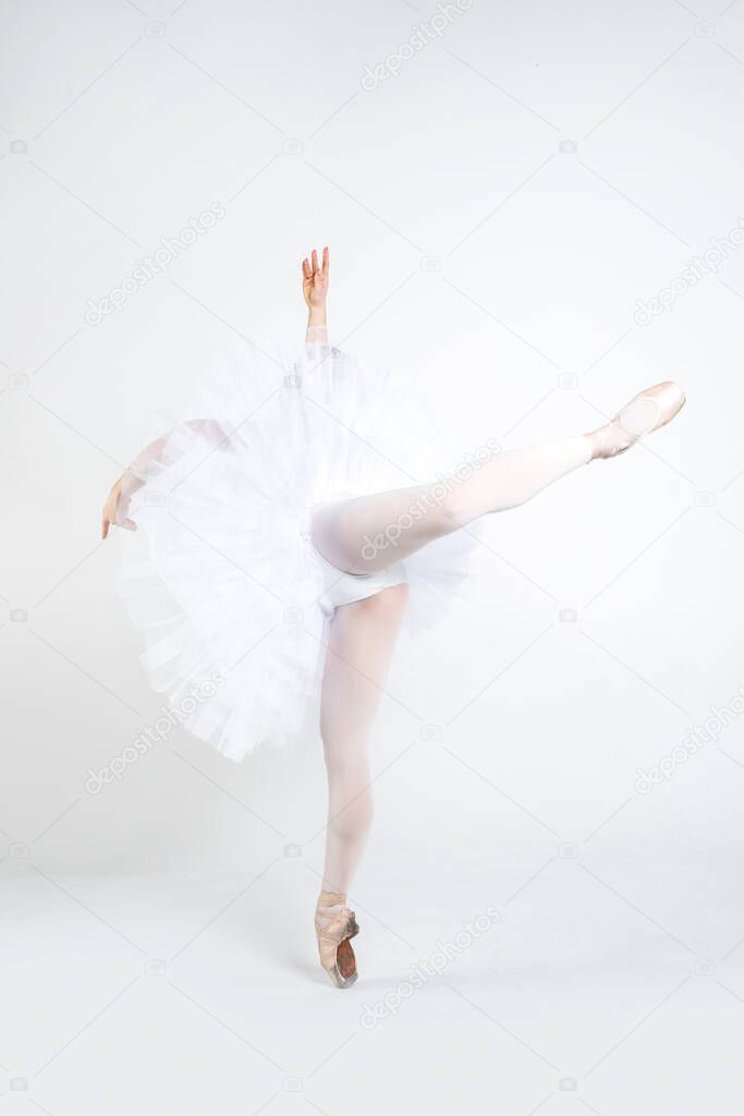 Young ballerina practising ballet moves in the studio