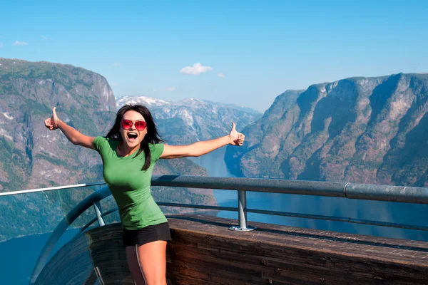 Excited woman tourist at Stegastein Viewpoint — Stock Photo, Image