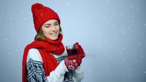 Chica de invierno en rojo cálido sombrero de punto y bufanda celebración taza de té — Vídeos de Stock