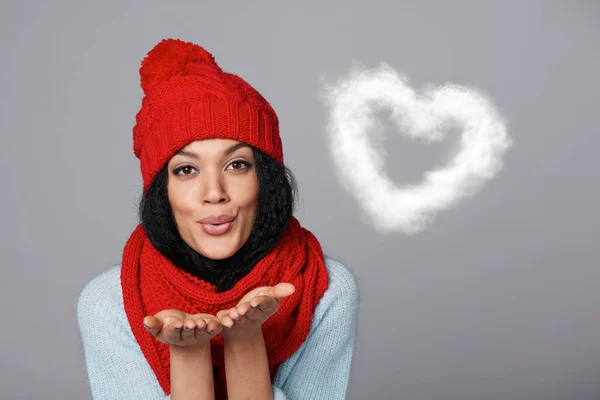 Winter girl blowing cloud heart shape — Stock Photo, Image