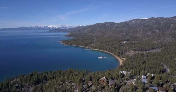 Lake Tahoe coastline and mountains covered by snow — Stock Video