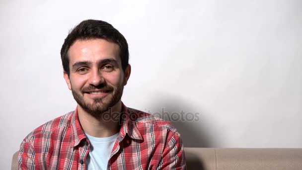 Man sitting on the sofa smiling at camera — Stock Video