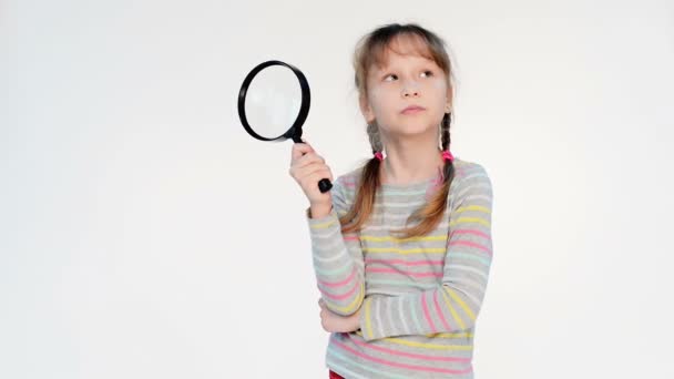 Little girl standing with magnifying glass — Stock Video