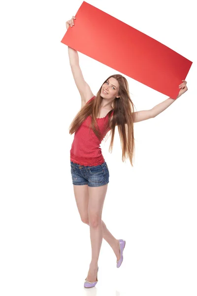 Full length young woman holding red blank cardboard over head — Stock Photo, Image