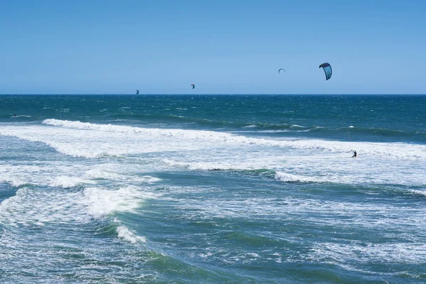 Fernsicht auf Kitesurfer, die auf den Wellen reiten — Stockfoto
