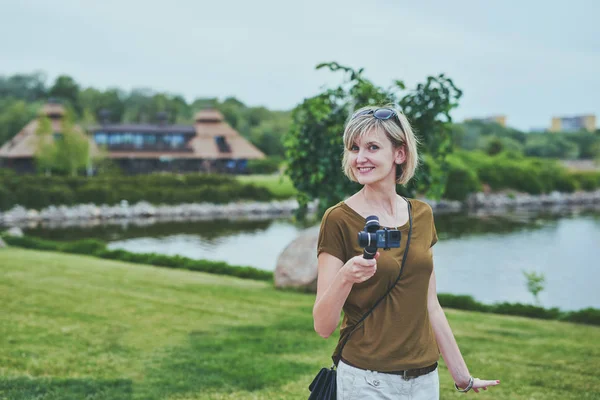 Woman filming with small personal camera — Stock Photo, Image