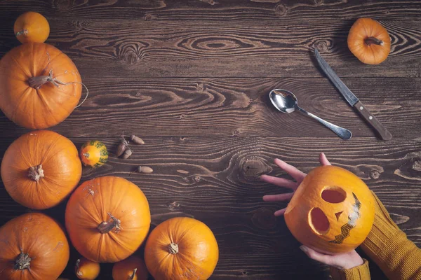 Hands holding Halloween pumpkin top view Stock Image