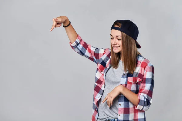 Teen girl pointing down at empty copy space — Stock Photo, Image