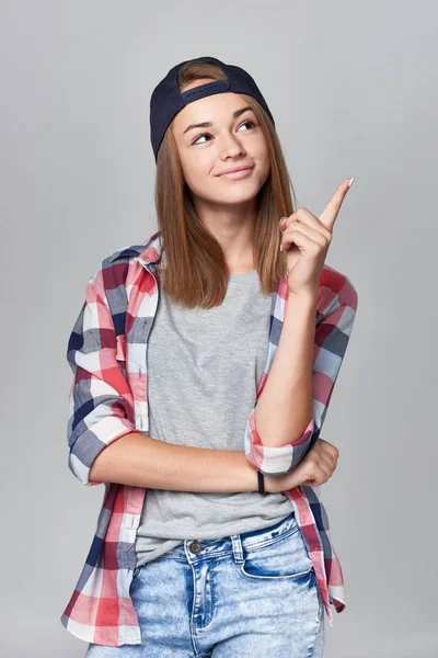 Teen girl pointing at empty copy space — Stock Photo, Image