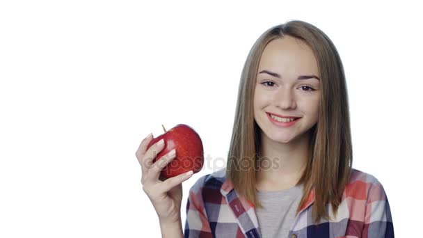 Smiling girl biting big green pear apple — Stock Video