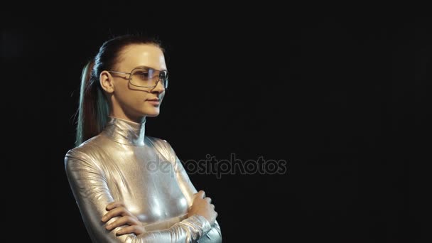 Futuristic woman in silver suit and goggles looking to side — Stock Video