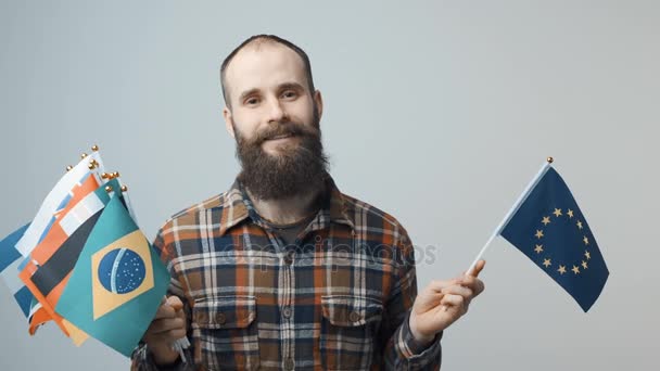 Man holding national flags — Stock Video