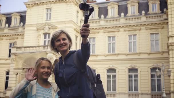 Woman with kid tourists capturing themselves with small personal camera — Stock Video