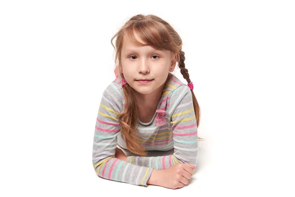 Front view of a child girl lying on stomach — Stock Photo, Image