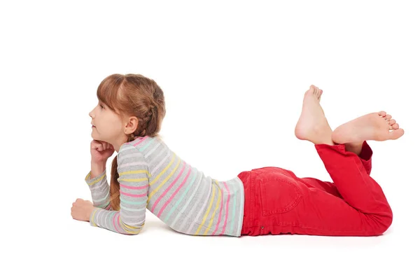 Child girl lying on the floor looking forward Royalty Free Stock Photos