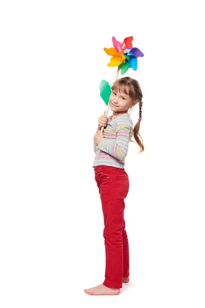 Chica con colorido molino de viento de longitud completa — Foto de Stock