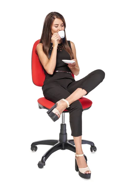 Woman with coffee cup sitting in office chair — Stock Photo, Image