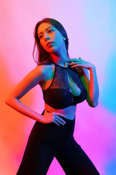 Beauty fashion portrait of female in black lingerie with colorful neon light — 스톡 사진