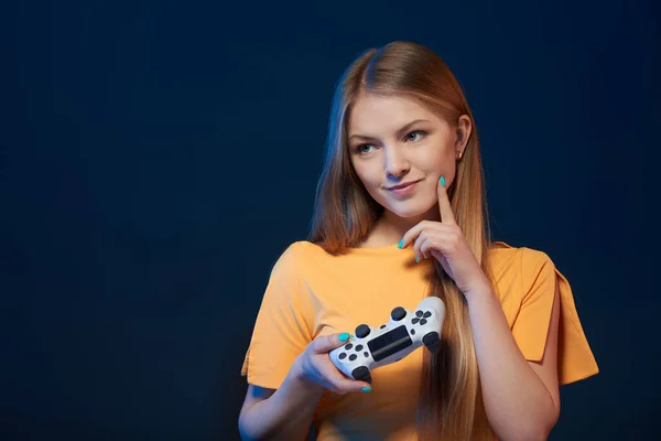 ゲーマーの女の子 笑顔の女の子を保持ビデオゲームジョイスティックを見て側の考え方 上の青の背景 — ストック写真