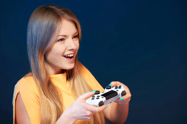 Emotional girl playing video game with joystick — Stock Photo, Image