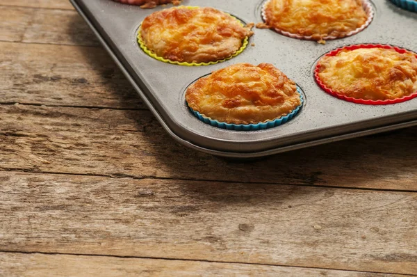 Savory cheese and bacon muffins on the wooden table — Stock Photo, Image