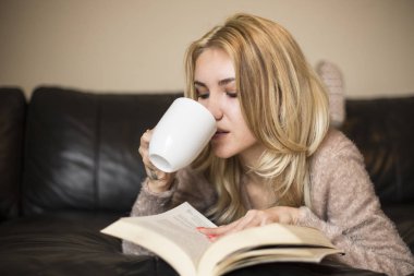 Kitap okuma ve kahve içme kadın