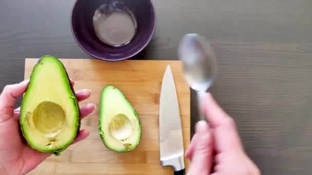 Closeup View Hands Separate Avocado Filling Spoon — Stock Video