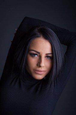 Çekici esmer kadın kameraya poz veriyor.