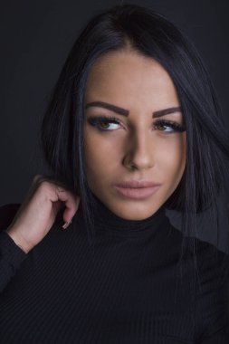 Çekici esmer kadın kameraya poz veriyor.