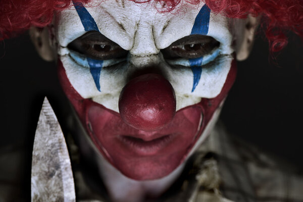scary evil clown with a knife
