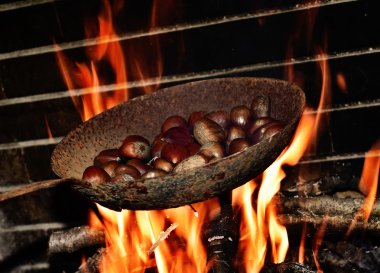 chestnuts roasting in the flames of a log fire clipart