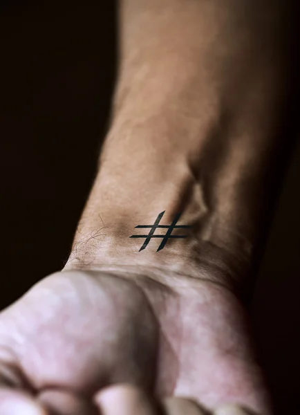 Hash tag in the wrist of a man — Stock Photo, Image