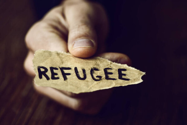piece of paper with the word refugee