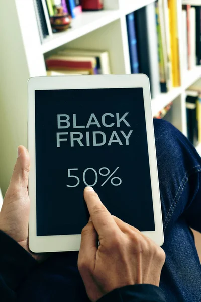 Man with a tablet with the text black friday — Stock Photo, Image