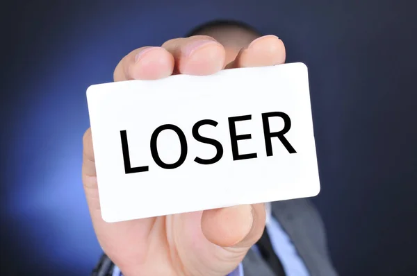 Man with a signboard with the word loser — Stock Photo, Image