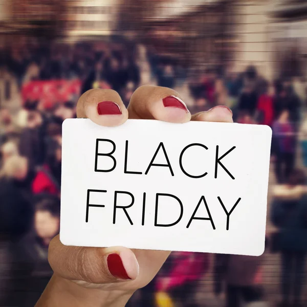 Woman with a signboard with the text black friday — Stock Photo, Image