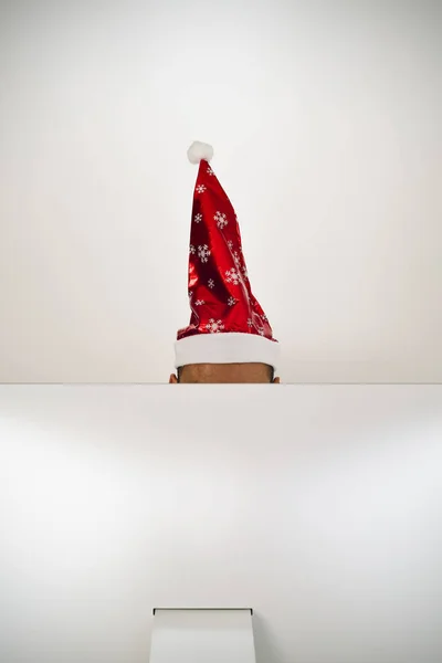 Man met een kerstmuts in zijn kantoor — Stockfoto