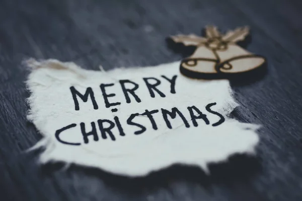 Texto feliz Natal em um pedaço de papel — Fotografia de Stock