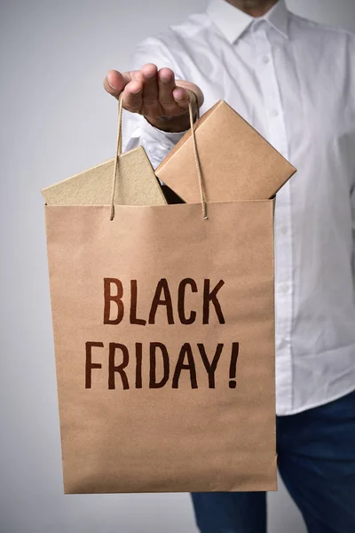 Shopping bag full of boxes and text black friday — Stock Photo, Image