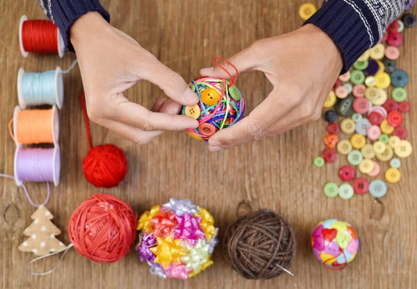 Man making a handmade christmas ball — Stock Photo, Image