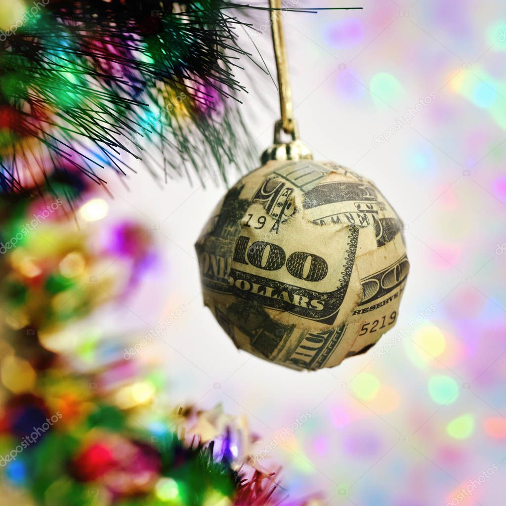 christmas ball wrapped in a banknote