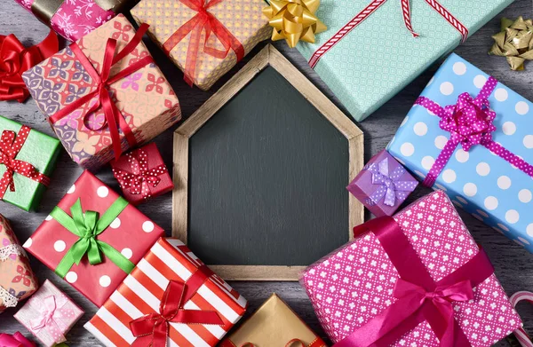 Gifts and blank chalkboard — Stock Photo, Image