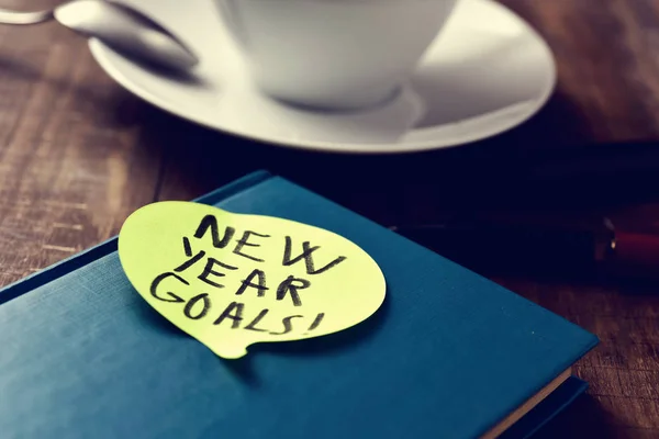 Text new years goals in a notepad — Stock Photo, Image