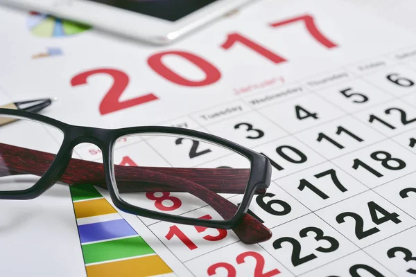 Eyeglasses, charts and 2017 calendar — Stock Photo, Image