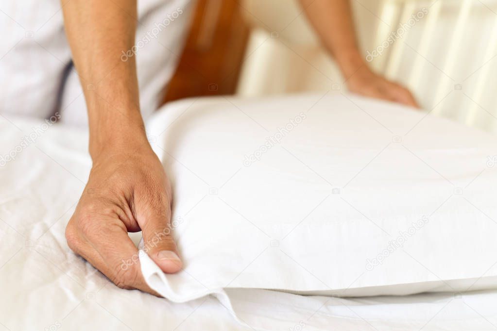 young man making the bed