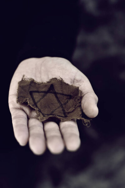 man with a ragged Jewish badge