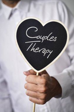 man with signboard with text couples therapy clipart